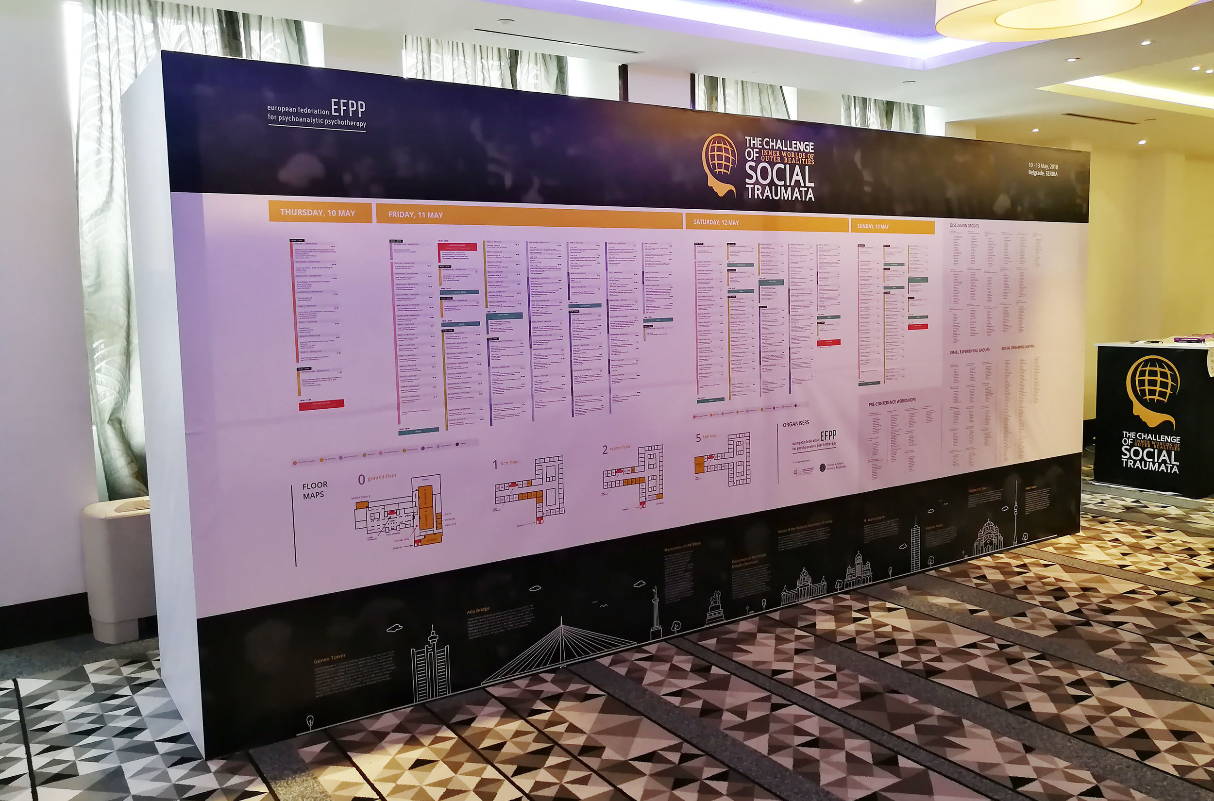 efpp conference brand design - photo of a big signage wall on the venue with event programme, floor maps etc
