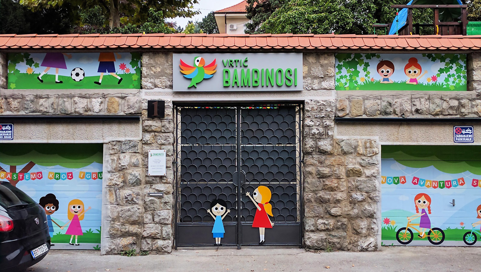 brand identity for a kindergarten - photo of a branded entrance with large graphics and signage above the door.